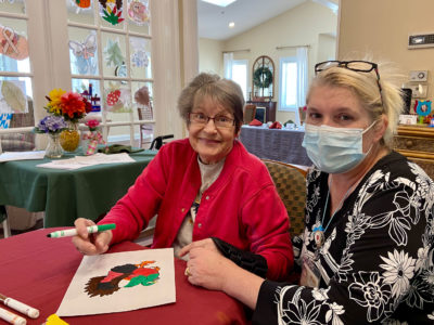 Senior doing arts and crafts at the assisted living facility