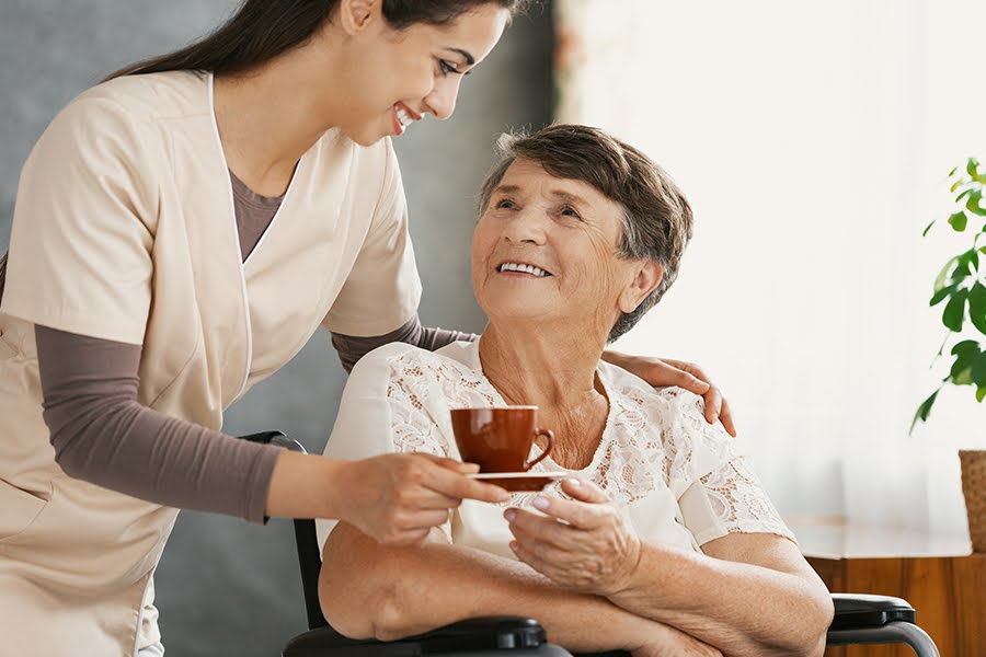 Caregiver offering soothing herbal tea to a senior woman as part of respite care in Elkton, Maryland