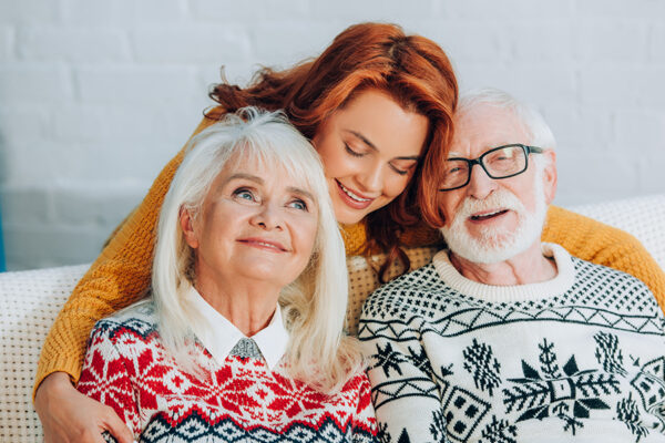 Daughter hugging her aging parents