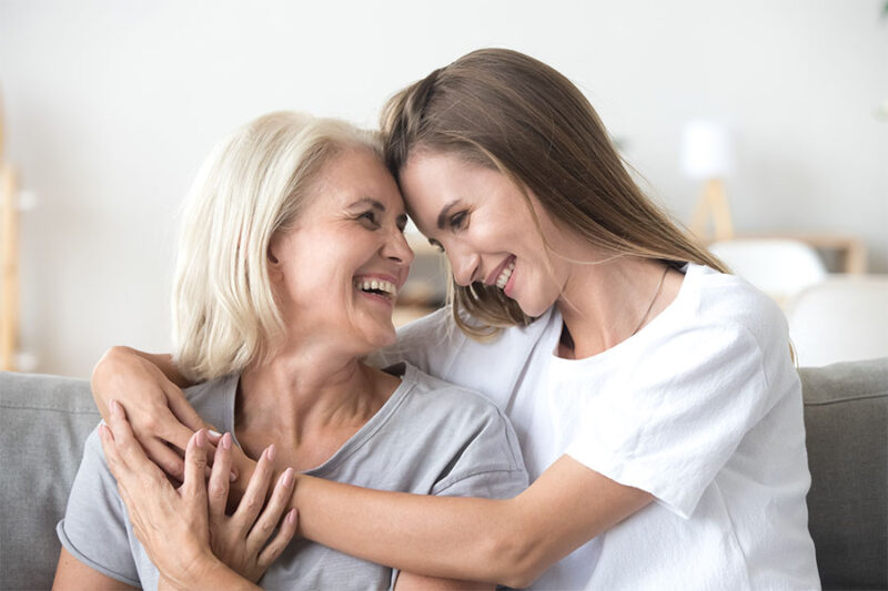 Daughter hugging her senior mother concept image for transition to assisted living