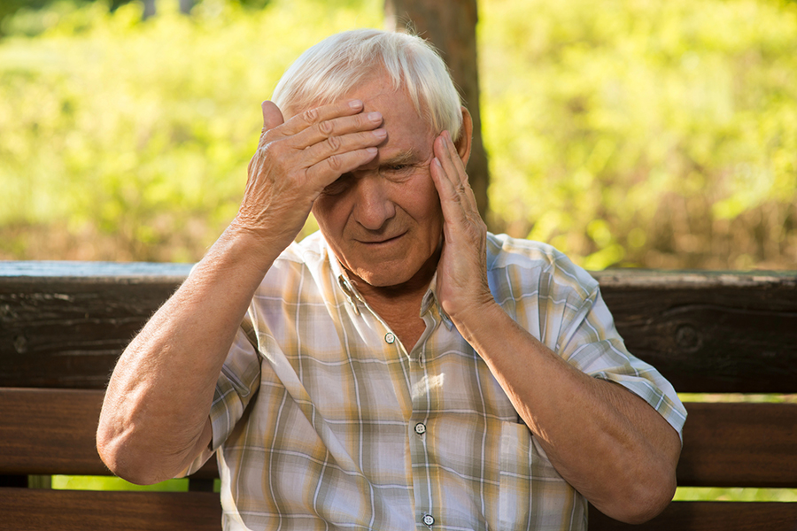 Elderly person showing early symptoms of heat stroke in elderly, like headache or dizziness, highlighting warning signs