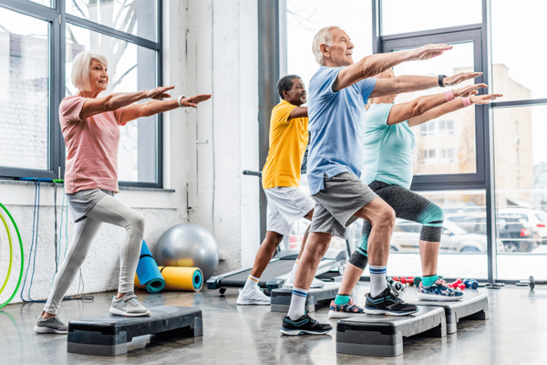 Group of seniors doing exercise to stay active in assisted living