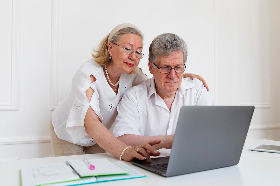 Senior couple using a laptop concept image for end of life planning
