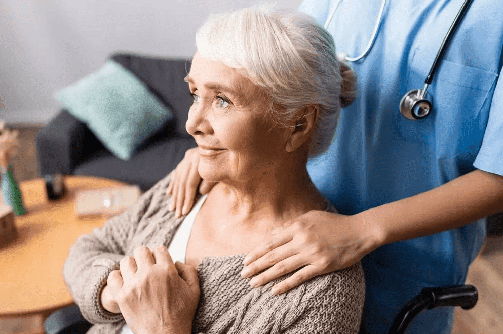 Senior woman in a wheelchair comforted by a nurse, representing residential senior care in Elkton, MD