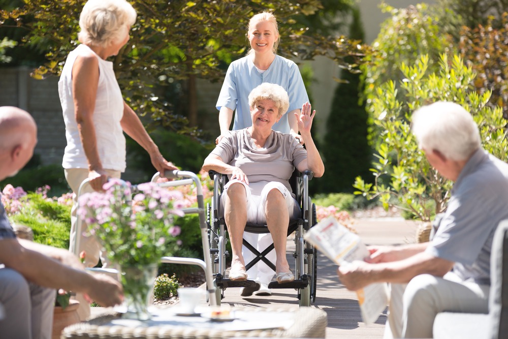 Group of older adults talking in the garden