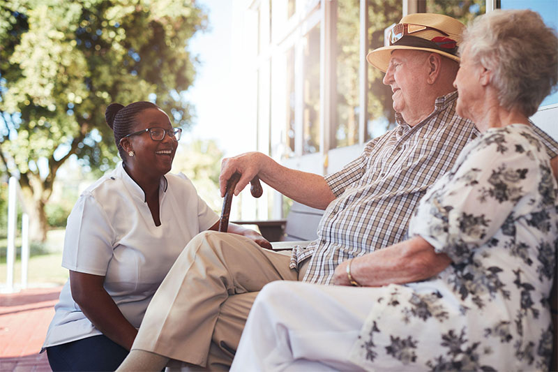 Health care provider having a conversation with the elder woman.