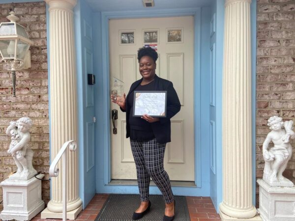 A staff member holding an award at our assisted living facility in Maryland