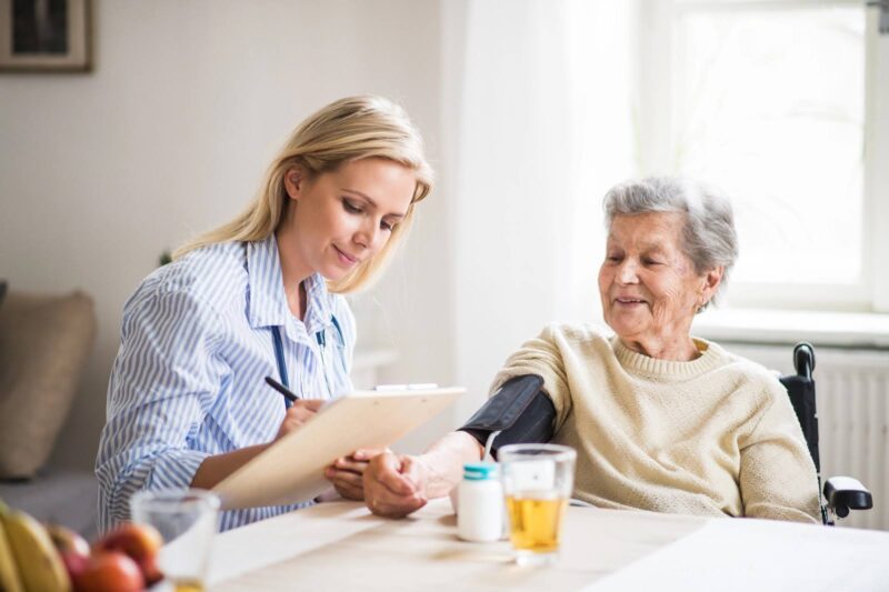 A caregiver creating a personalized care plan for an elderly resident at Catered Living