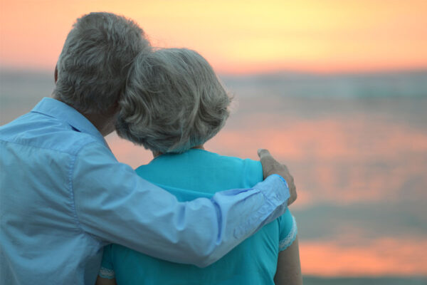 A senior couple watches the sunset at Ocean City Beach, one of the most popular attractions for seniors in the Ocean Pines area