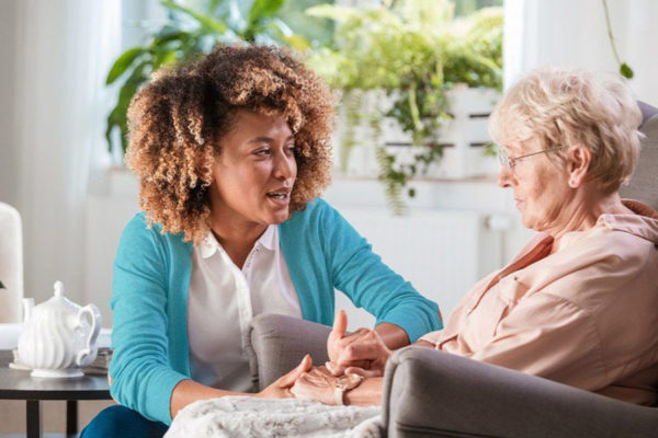 Caregiver taking care of senior lady with dementia.