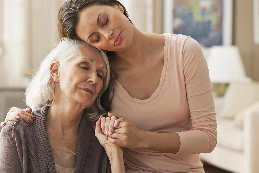 How to move a parent with dementia to assisted living concept image of a daughter consoling her mother.