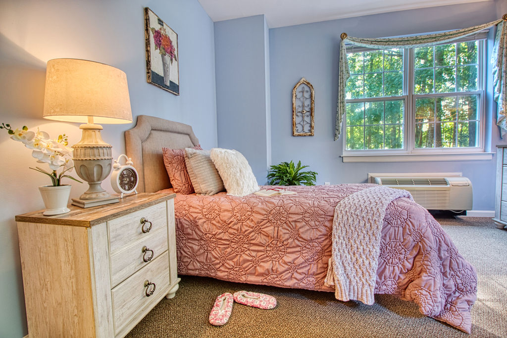 Another cozy bedroom view at an assisted living facility in Ocean Pines, MD, with large windows.