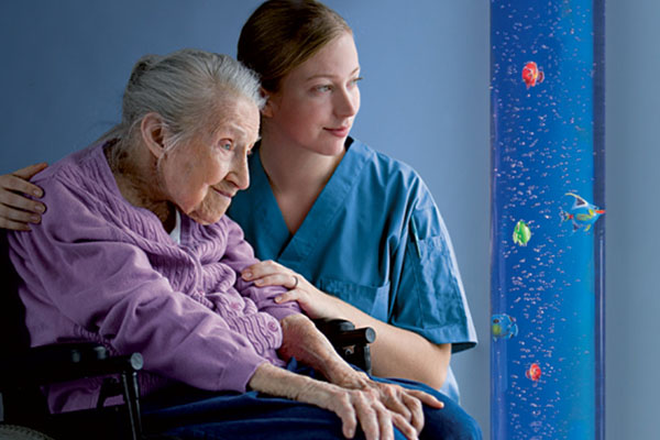 Nurse with senior lady inside the multi sensory room for patients with dementia