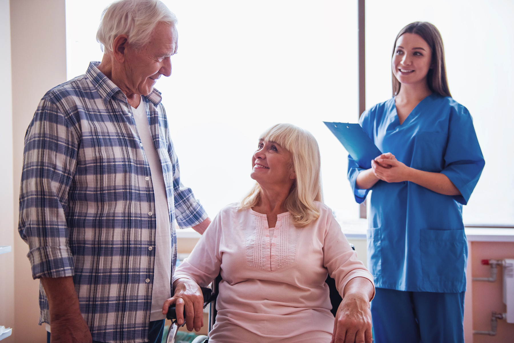 Senior couple with their caregiver illustrating common behaviors of dementia