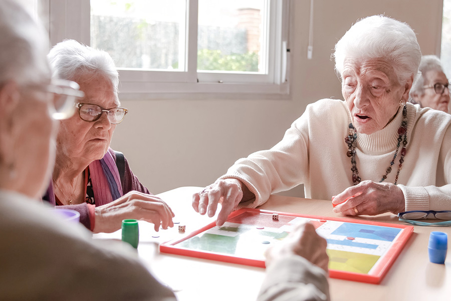 Seniors engage in stimulating board games at a memory care near Berlin, MD, to support cognitive health.